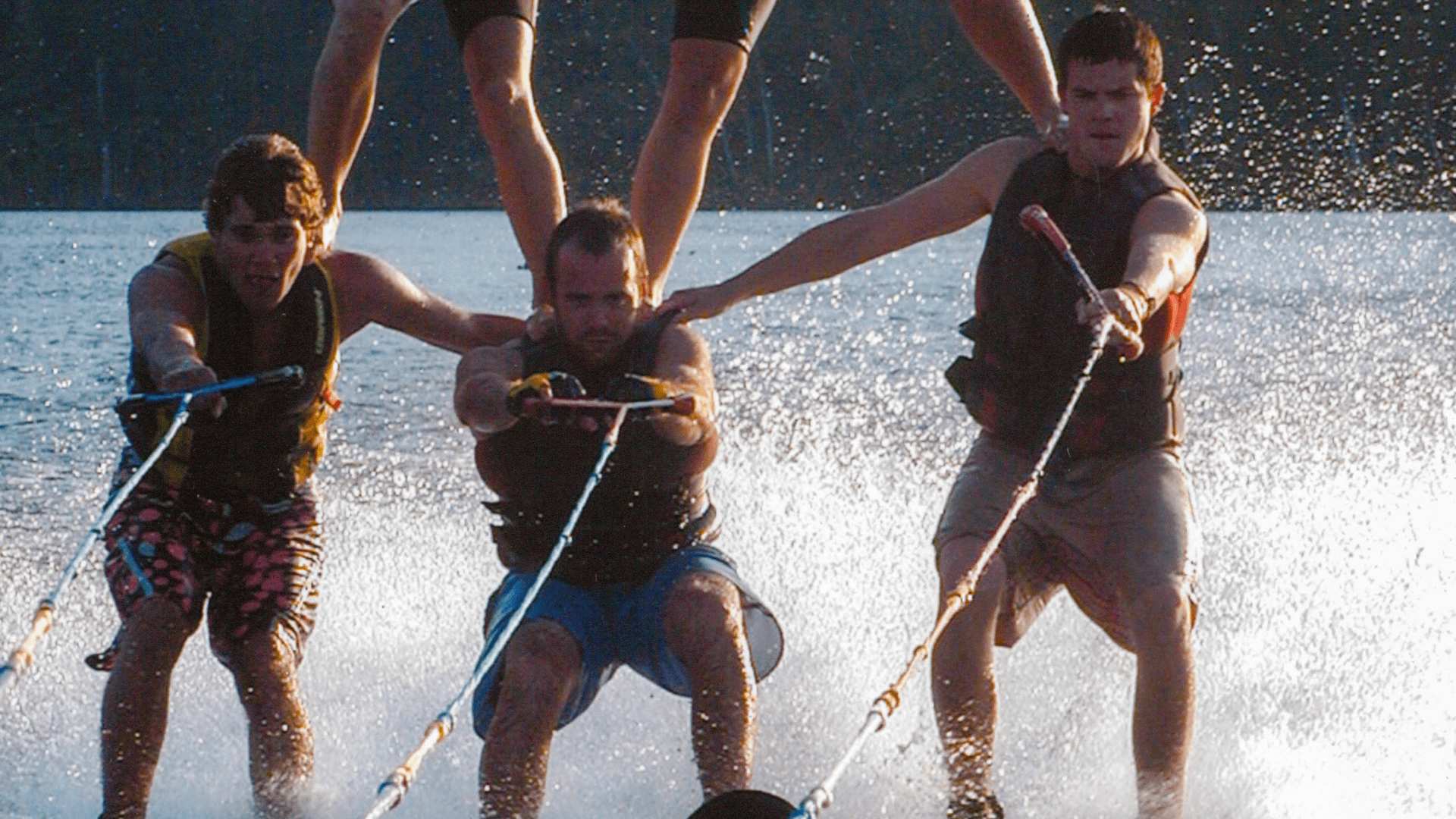 Several people water skiing together on a bright sunny day.