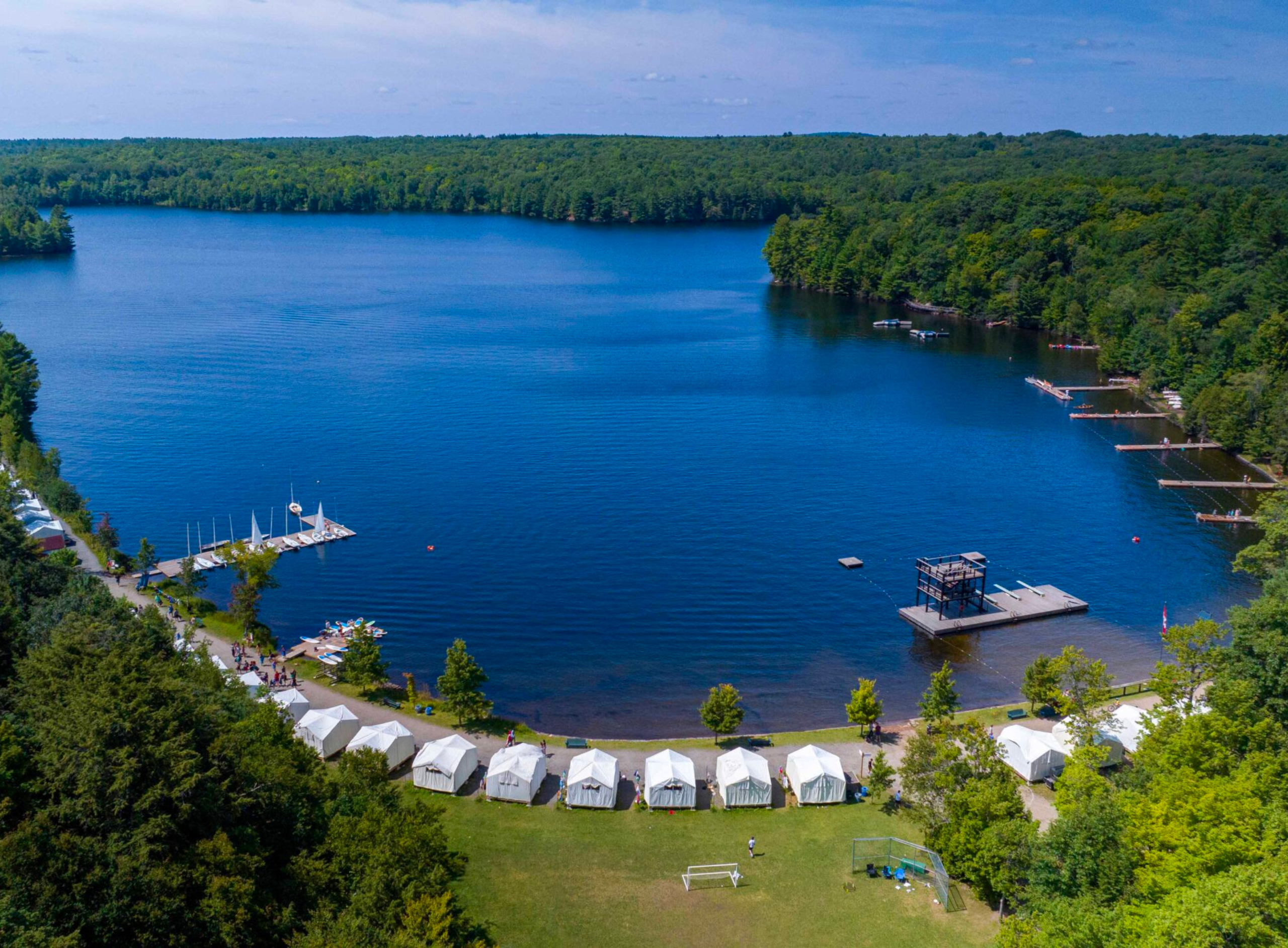 High angle view of a deep blue lake and shoreline.